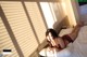 A woman laying on a bed in a bedroom.