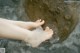 A person's feet in a stream of water.