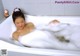 A woman laying in a bathtub filled with foam.