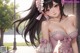 Anime girl with long black hair wearing a pink dress.